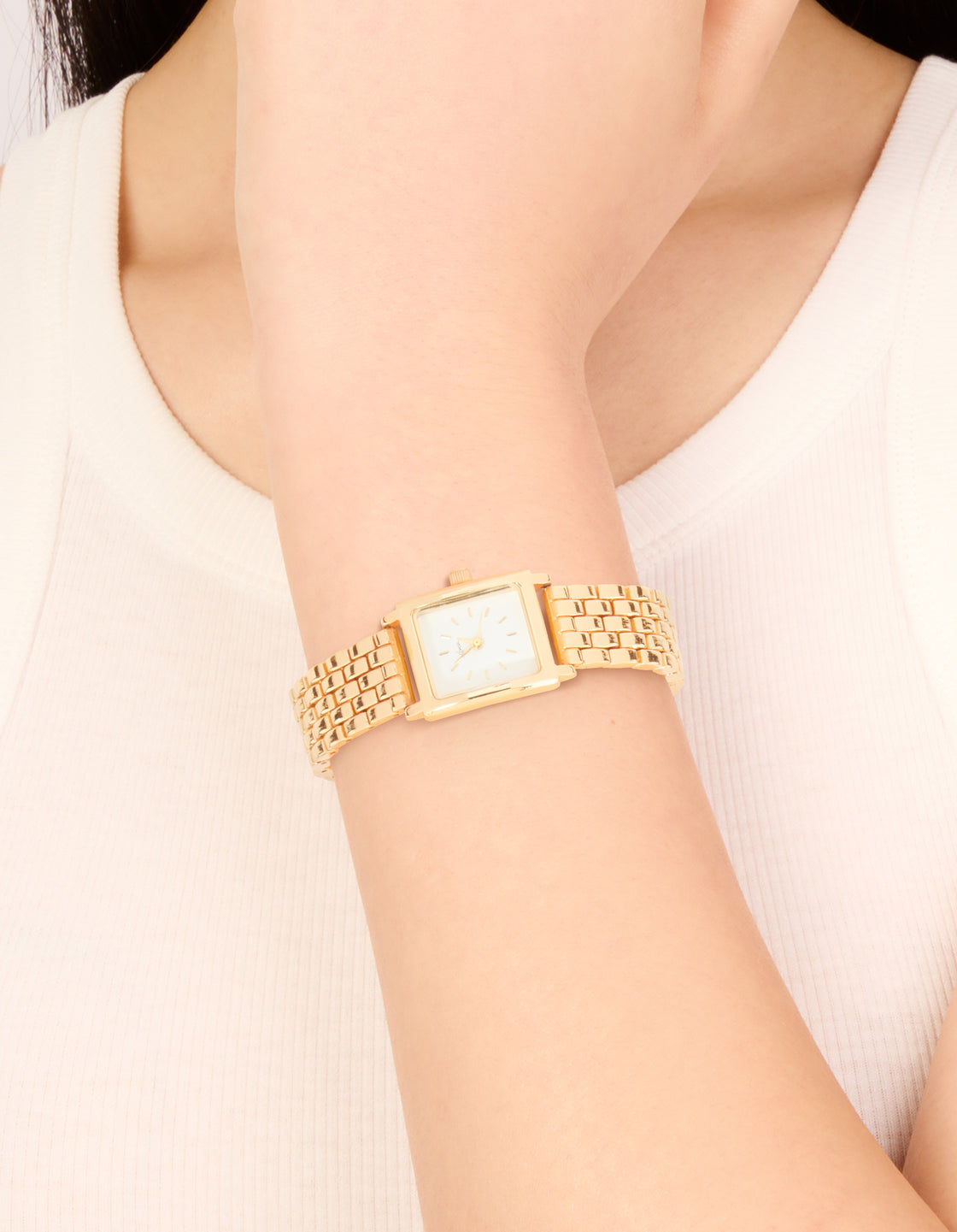 Crafted for women, this white dial square watch features link band in gold with formal occasion styling and statement analog details on wrist view
