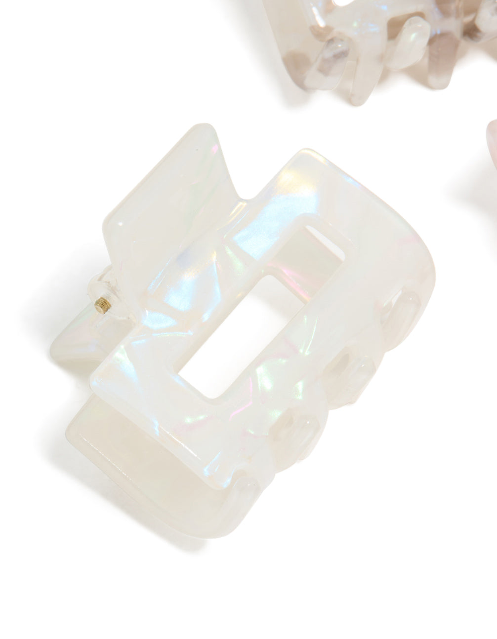 Crafted from solid acrylic, these mini rectangle claw clips in a 3-pack display light pink, beige, and ivory detail view