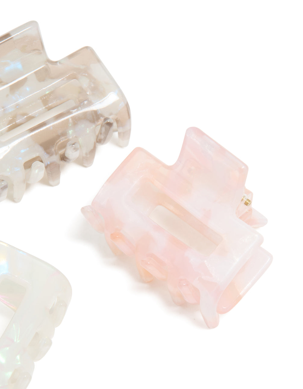 Designed with solid acrylic, these mini rectangle claw clips in a 3-pack feature light pink, beige, and ivory side view