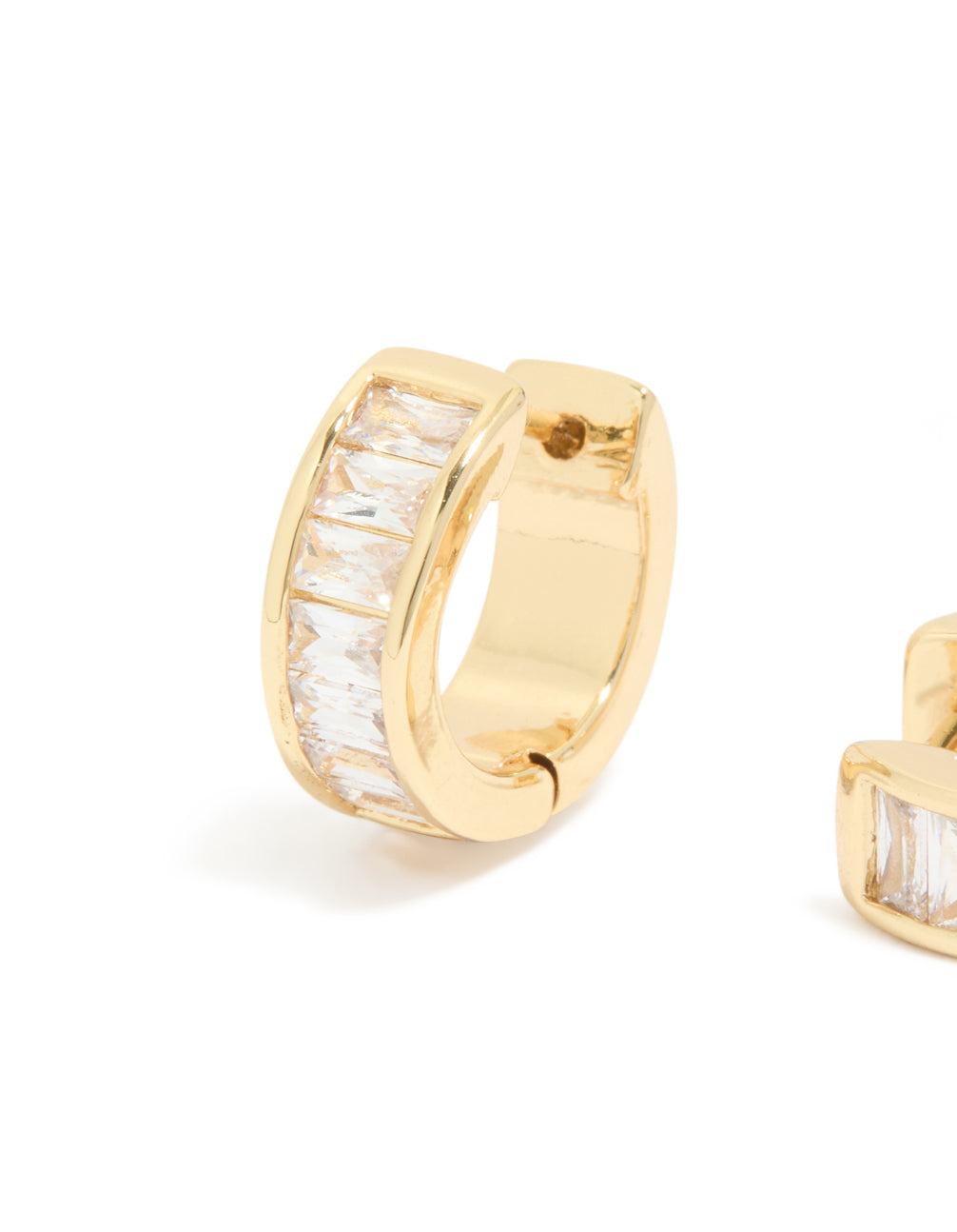 Featuring gold plated cubic zirconia inlay huggie earrings with channel-set baguette stones and closure mechanism close up view