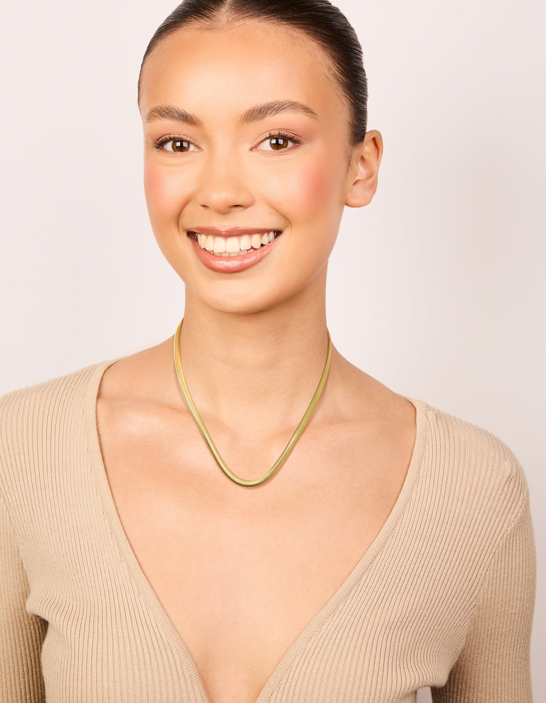 Designed with waterproof gold plated stainless steel thick snake chain necklace featuring statement styling on model view