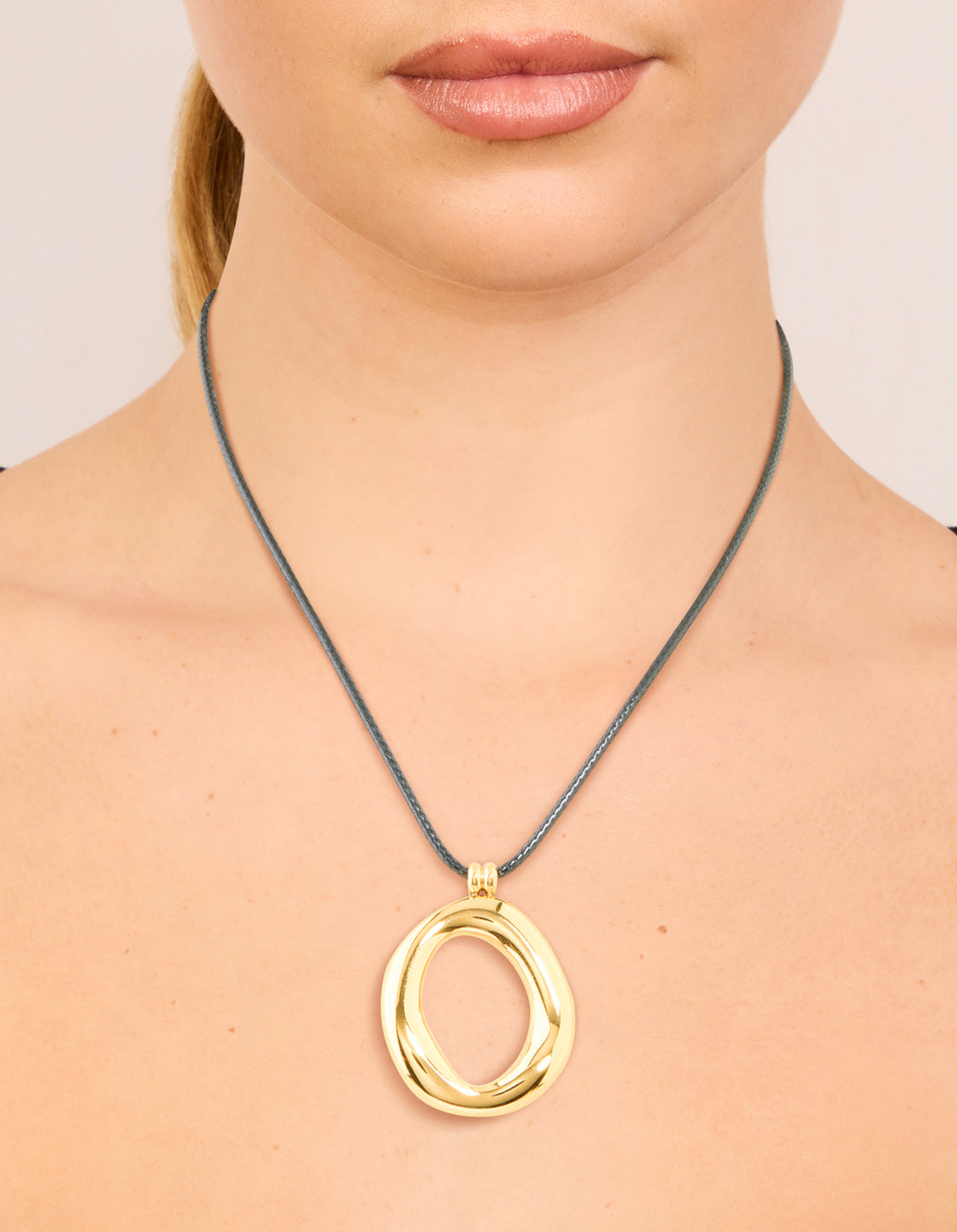 Featuring a waterproof gold plated organic open pendant cord necklace stainless steel on neck view