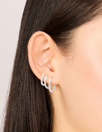 Showcasing waterproof stainless steel cubic zirconia clicker hoop earring pack in silver on ear view - link has visual effect only