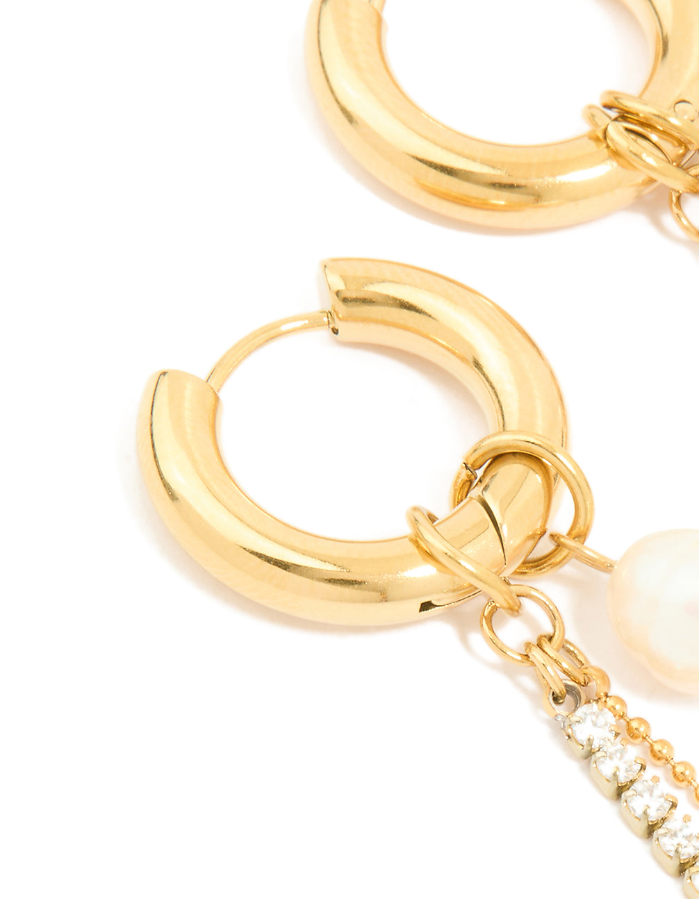 Featuring waterproof gold plated stainless steel with freshwater pearl charm and diamante cup chain detail huggie closure close up view