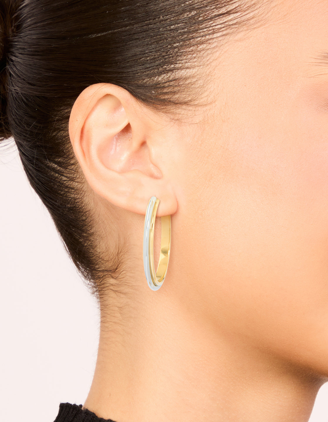 Shop waterproof mixed metal plated stainless steel large illusion hoop earrings in statement style with gold and silver closure on ear view