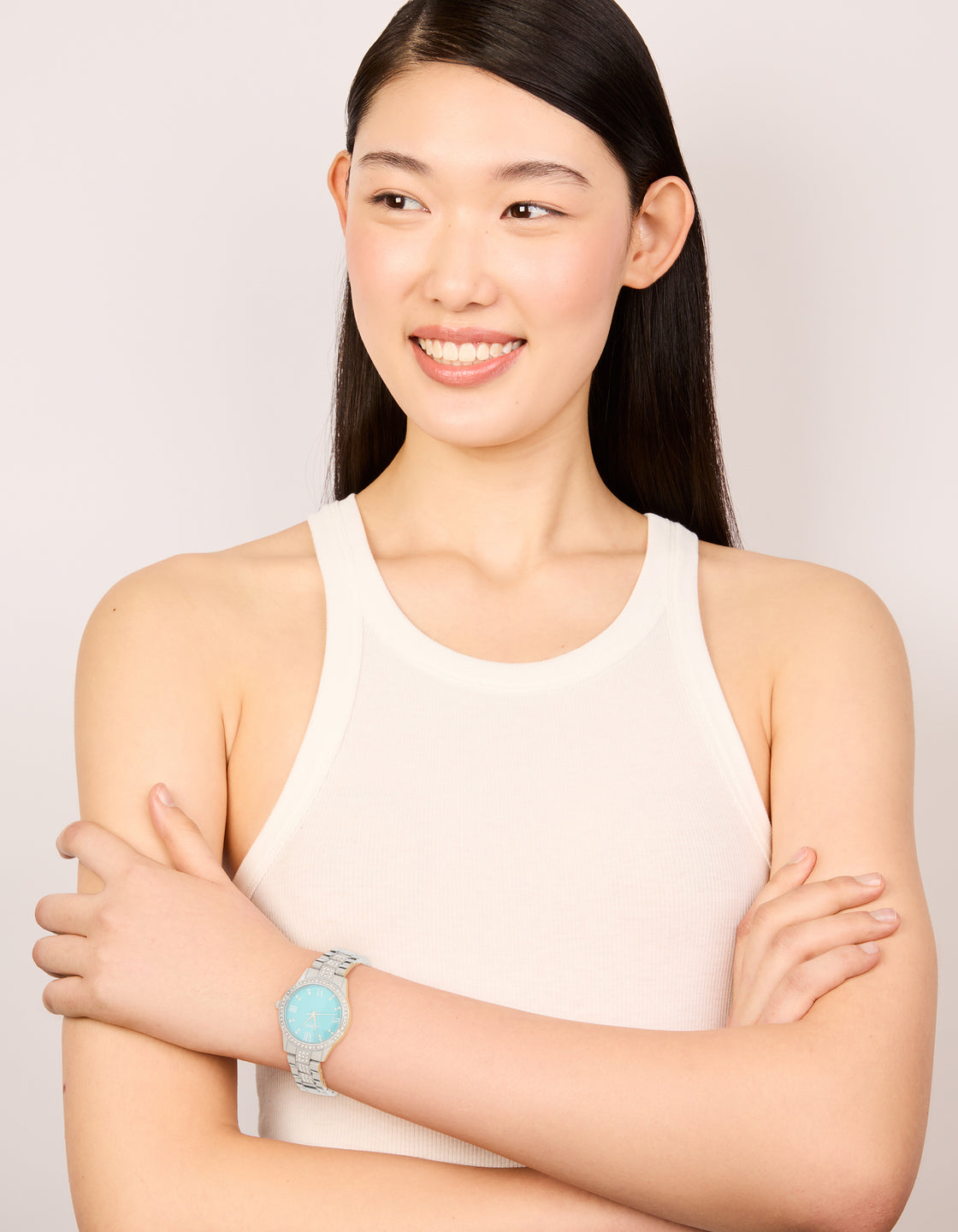 Stylish diamante watch with roman numeral blue faced dial, round shape, women's formal analog timepiece featuring link band in silver on model view