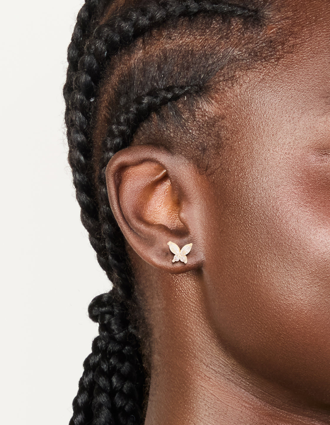Featuring waterproof stainless steel butterfly stud earrings with cubic zirconia in silver and clear tones on ear view