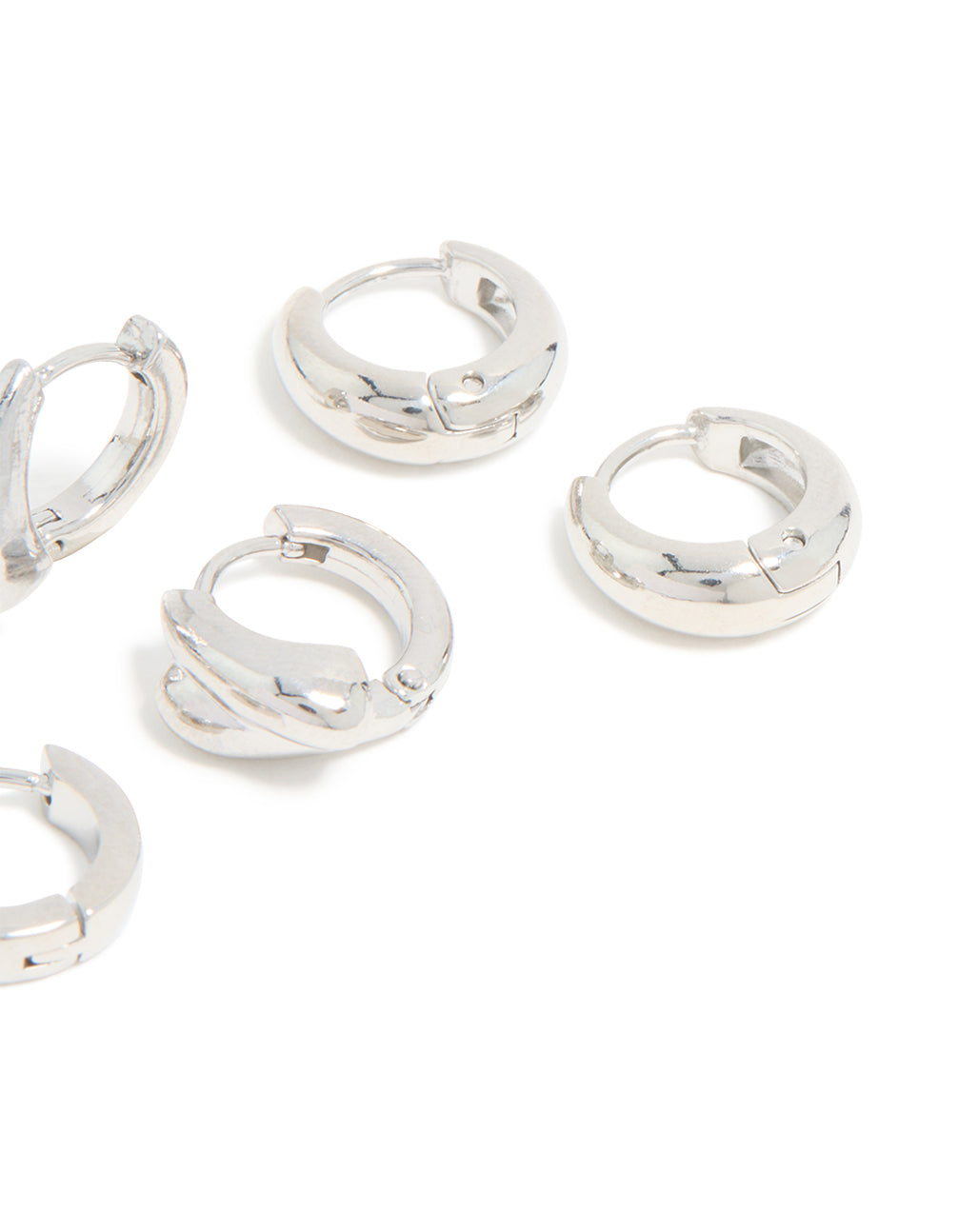 Showcasing chunky huggie earrings made from waterproof stainless steel in silver, displayed as a 3-pack post detail view