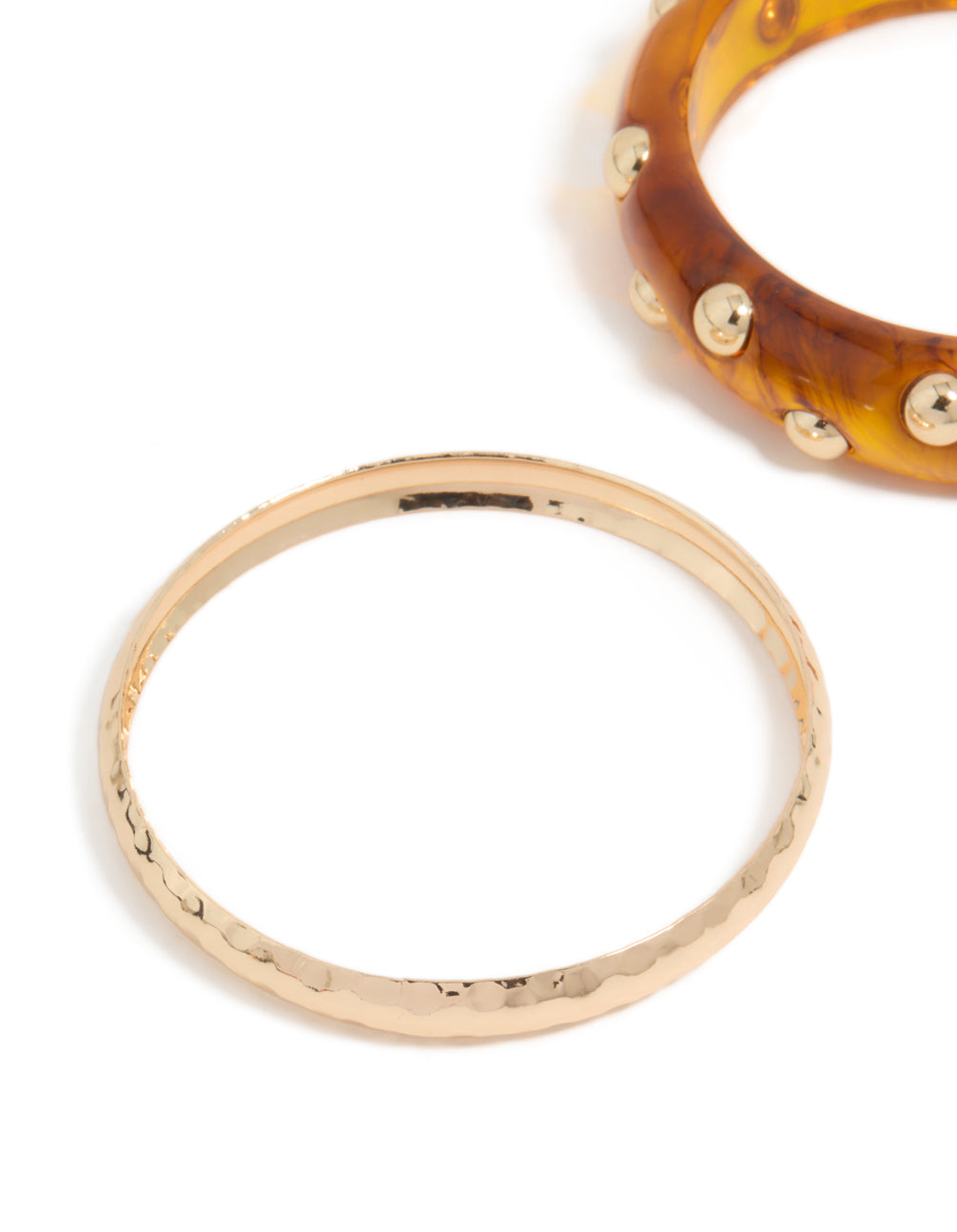 Shop this 2-pack studded acrylic bangle set with gold and brown hues in close up view