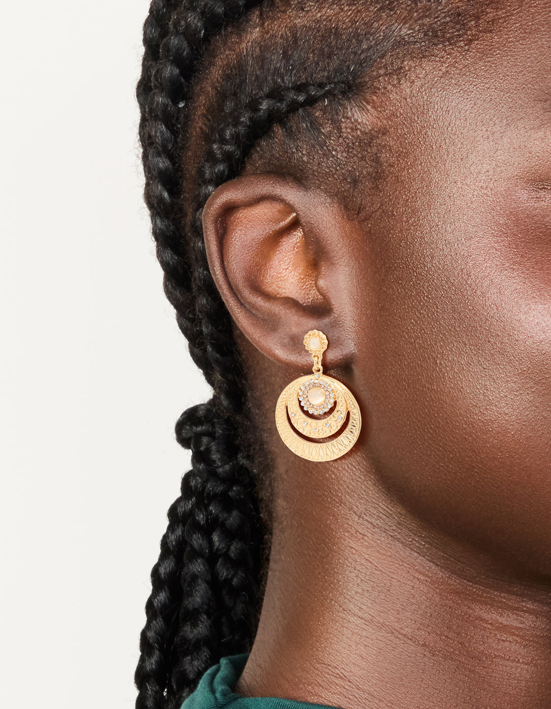 Showcasing gold plated boho circle drop earrings on ear view