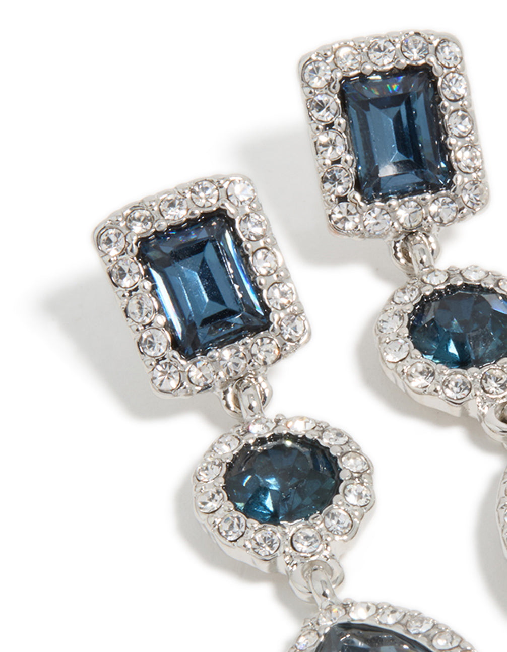 Close view of rectangular and circular gemstone tiers in teal with surrounding crystals detail in close up view