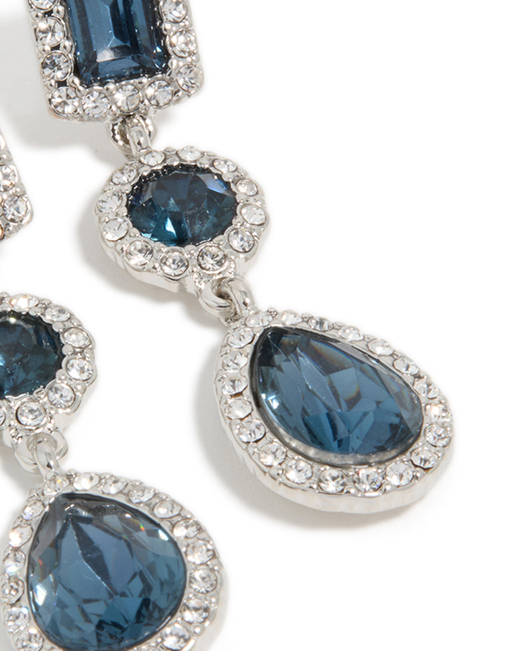 Intricate detailing of teardrop and round blue stones framed by sparkling diamantes in earrings post detail view