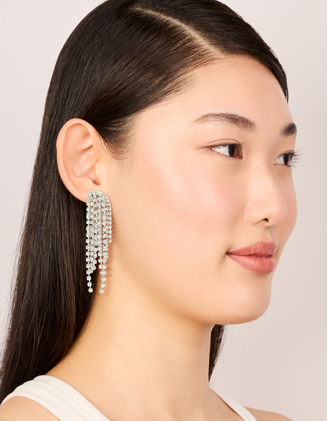 Showcasing silver diamante dazzle tassel drop earrings with statement style front view