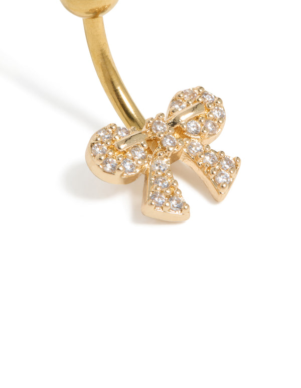 Highlighting a bow belly bar with cubic zirconia pavé, crafted from gold plated surgical steel design detail view