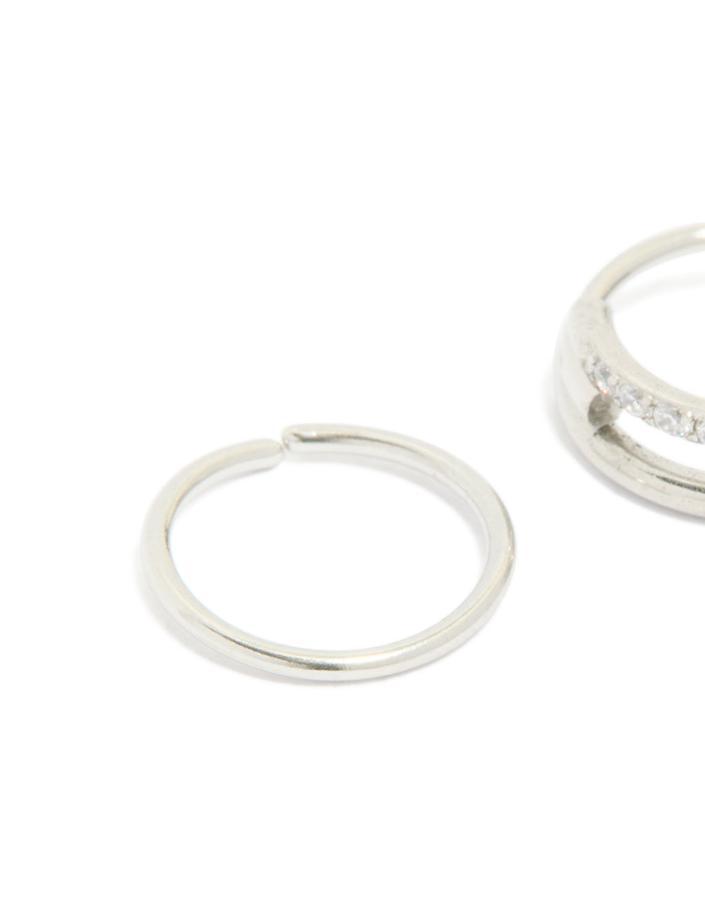 Designed with surgical steel cubic zirconia hinged and simple nose rings in a 2-pack with diamond accents and statement style close up view