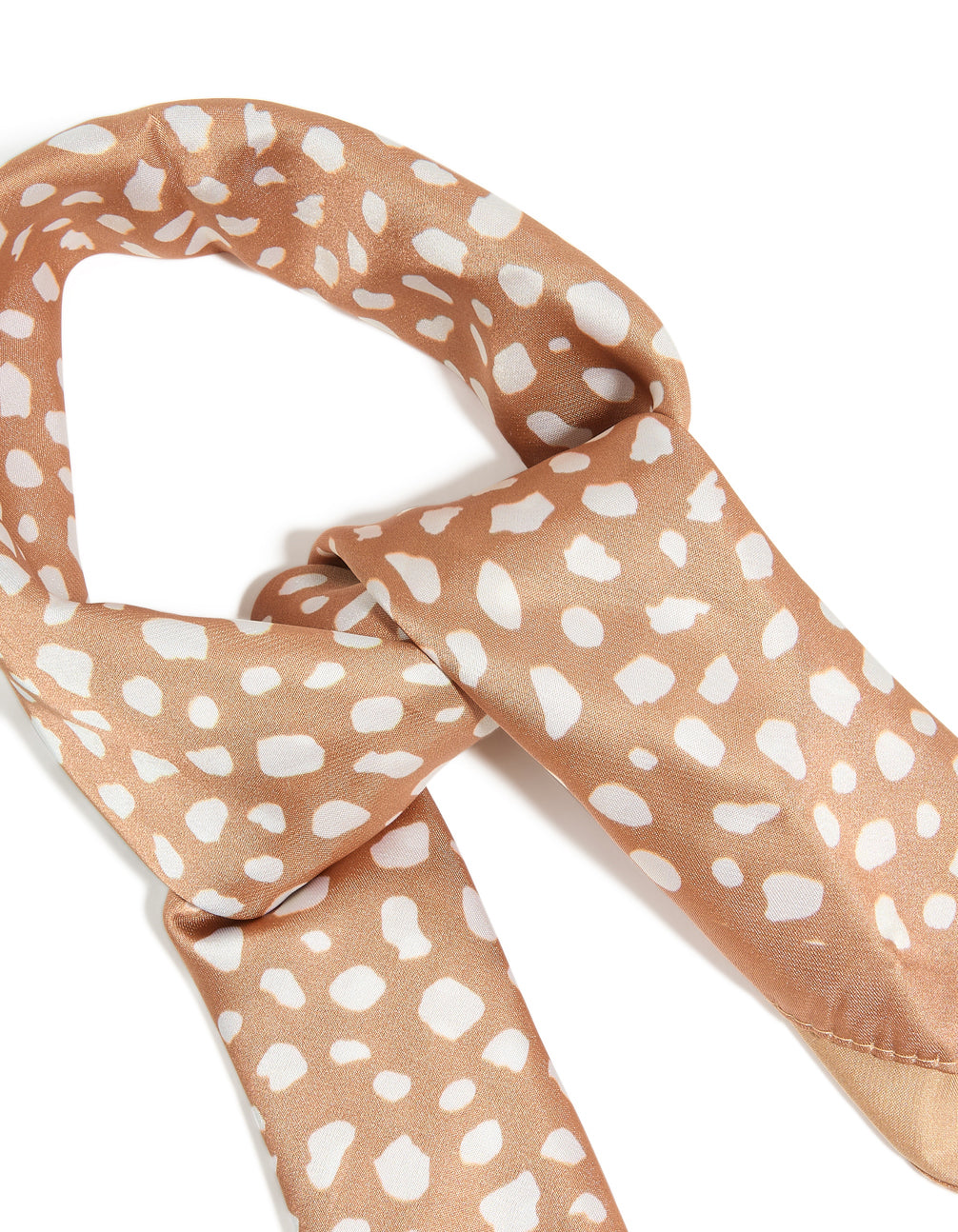 Elegant spotted deer print fabric scarf texture in tan and white detail view