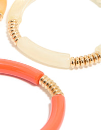 Showcasing brown and pink acrylic stretch bracelets in a 4-pack with gold accents close up view - link has visual effect only