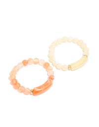 Showcasing pink and cream beaded stretch bracelets in a 2-pack with gold details front view - link has visual effect only