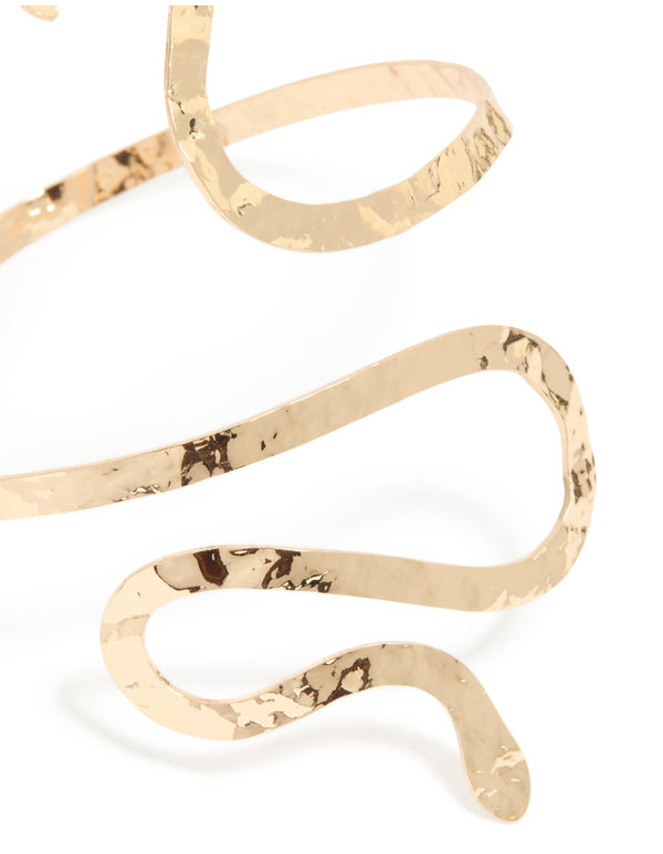 Beautifully designed snake swirl arm cuff featuring statement gold close up view