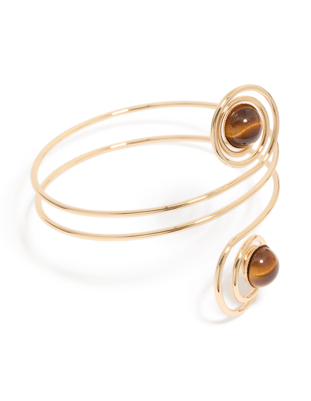 Showcasing a gold swirl and brown stones arm cuff with statement design front view