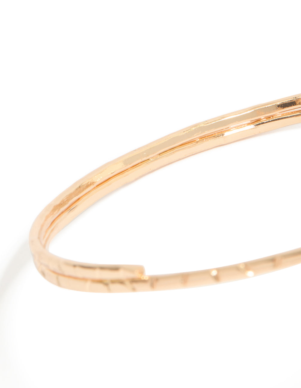 Crafted from gold, this double sun arm cuff features celestial motifs in a statement style in close up view