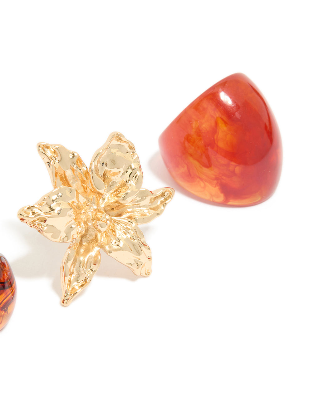 View the 3-pack of acrylic flower rings with coral, orange, and gold statement design detail view
