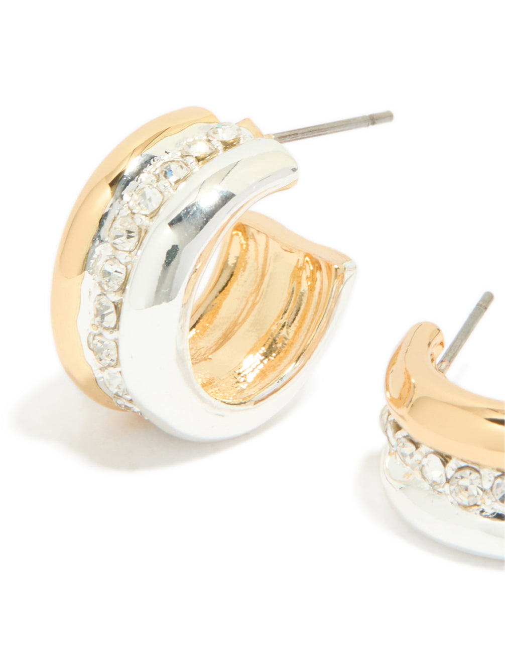 Highlighting mixed metal plated cubic zirconia detailed huggie earrings in gold, silver, and white close up view
