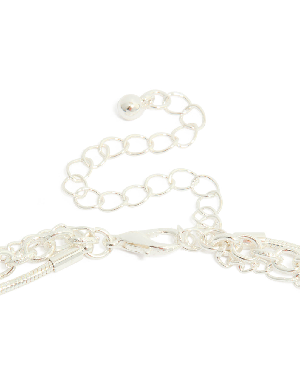 Highlighting a silver plated chain and diamante heart layered necklace clasp detail view