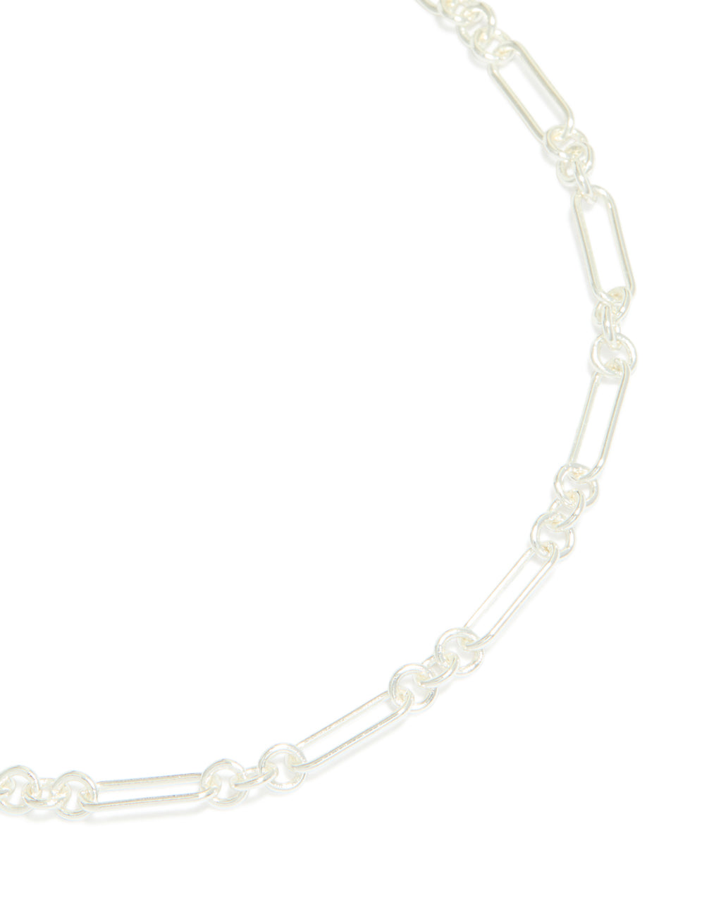 A silver plated long figaro chain necklace features intricate link details close up view