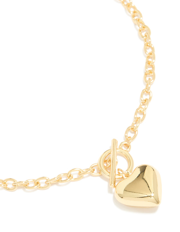 Featuring a gold plated heart charm necklace close up view