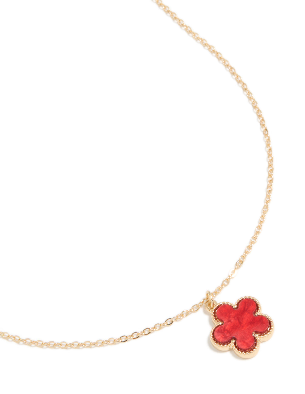 Showcasing a gold necklace featuring a red five petal flower pendant in statement style close up view