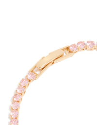 Presenting a gold pink cubic zirconia dainty tennis bracelet in light pink closure detail view - link has visual effect only