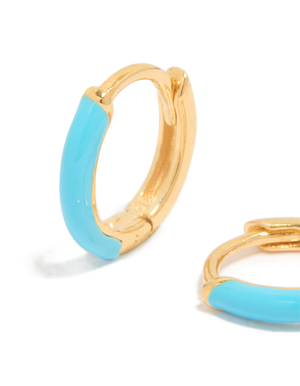 Featuring gold plated sterling silver light blue enamel huggie earrings with turquoise accents close up view