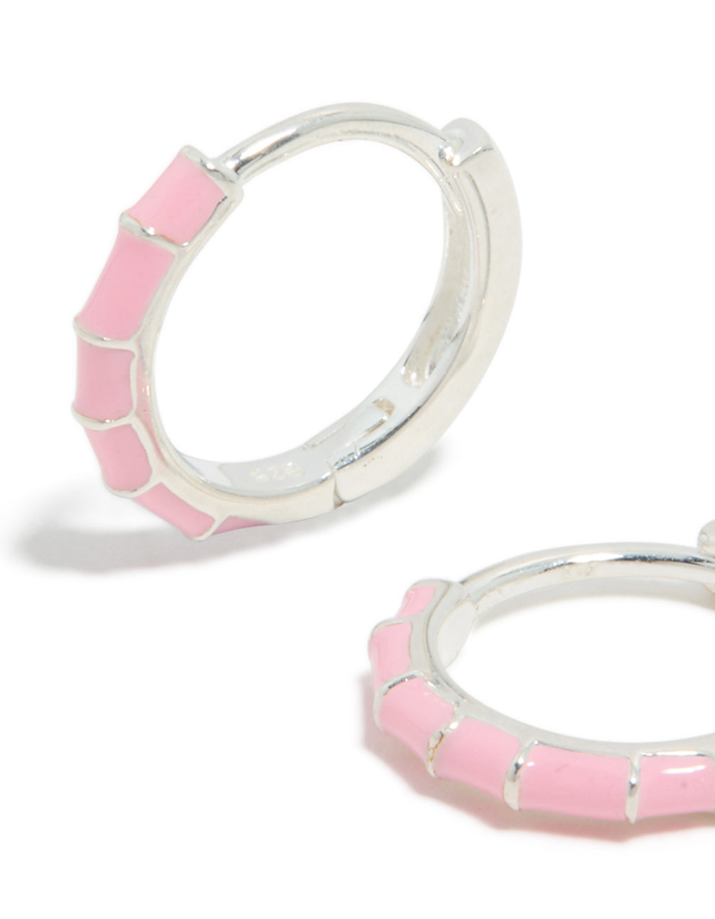 Detailed view of sterling silver pink enamel bamboo huggie earrings with hoop closure close up view