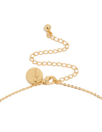 Highlighting the gold plated brass double cubic zirconia cross necklace with charm and statement design clasp detail view - link has visual effect only