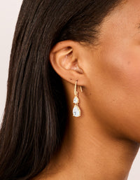 Showcasing gold plated cubic zirconia triangular drop hook earrings on ear view - link has visual effect only