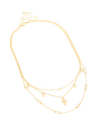 Finely crafted gold plated layered necklace featuring cubic zirconia bezel settings and cross pendant in statement design front view - link has visual effect only