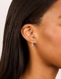 Discover skinny huggie earrings in silver plated finish with cubic zirconia on ear view - link has visual effect only