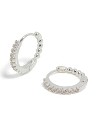 Showcasing skinny huggie earrings crafted from silver plated material featuring cubic zirconia front view - link has visual effect only