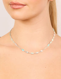 Showcasing a silver plated pink and blue cubic zirconia mixed oval necklace on neck view - link has visual effect only