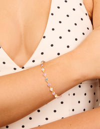 Showcasing a gold purple and grey cubic zirconia bracelet with lavender and light cyan accents on wrist view - link has visual effect only