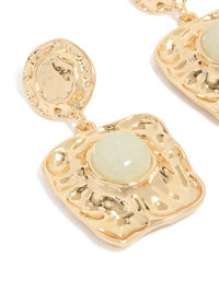 Capturing the molten texture and pale green stone detail of these gold statement square drop earrings close up view - link has visual effect only