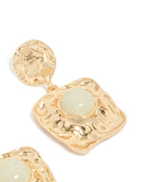 Featuring gold statement drop earrings with pale green stone and molten square design post detail view - link has visual effect only