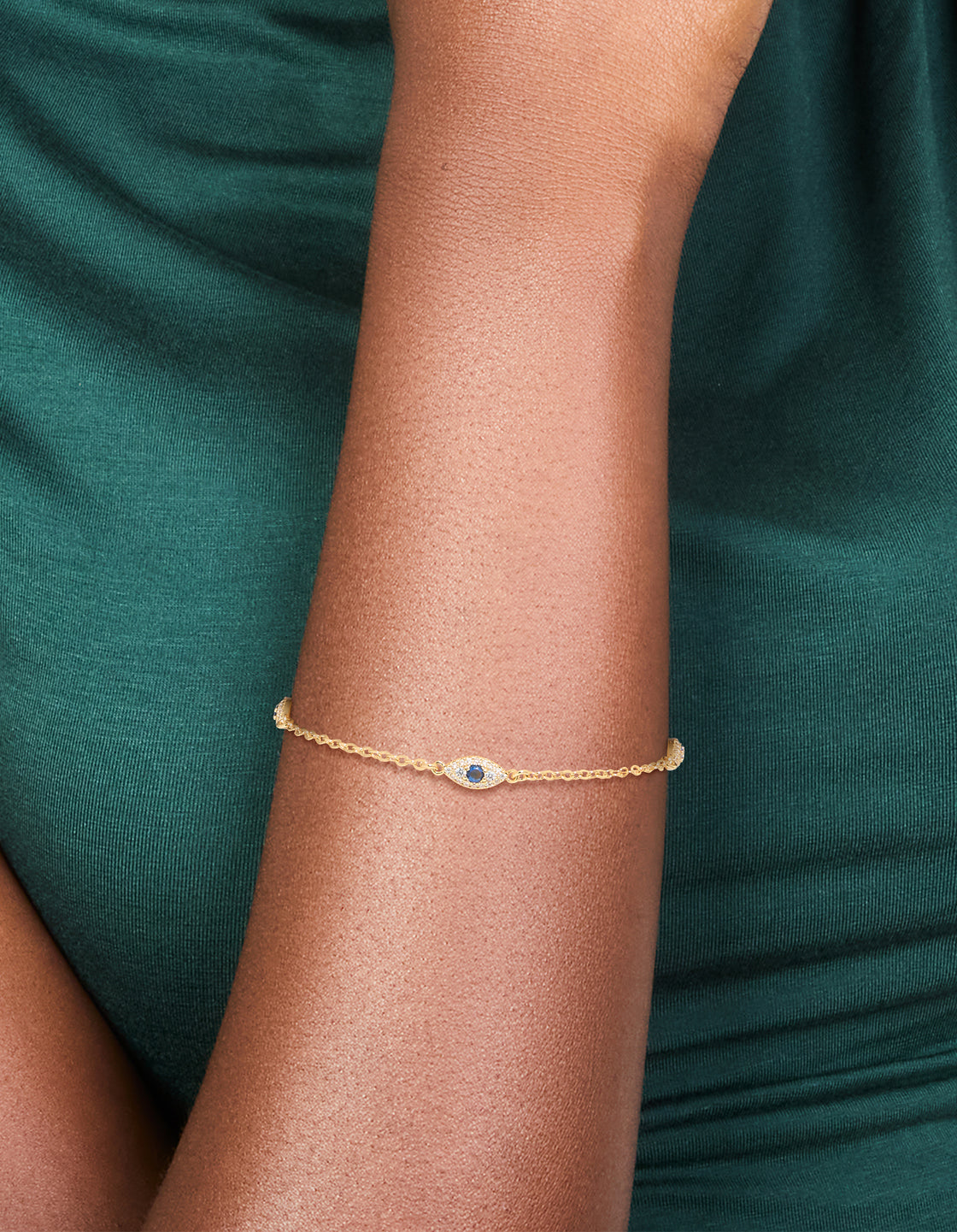 Beautifully crafted gold plated cubic zirconia evil eye trio bracelet worn on wrist view