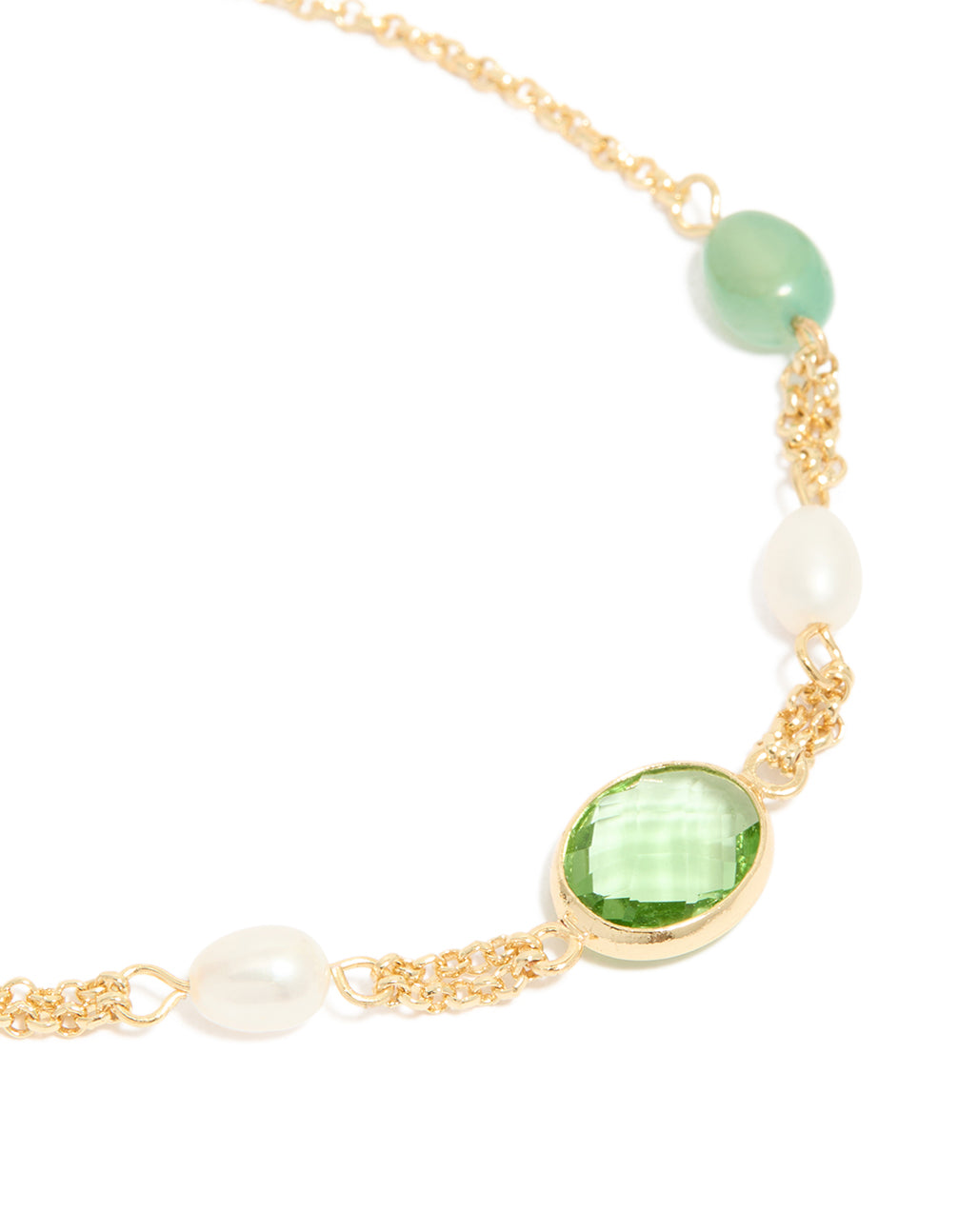 Highlighting gold plated green cubic zirconia freshwater pearl toggle bracelet with beads, close up view