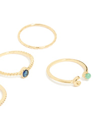 Showcasing gold plated celestial rings with moon, star and blue and clear cubic zirconia accents close up view - link has visual effect only
