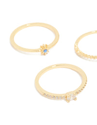 Detailed angle of gold plated celestial rings highlighting star and moon with blue and clear cubic zirconia stones side detail view - link has visual effect only