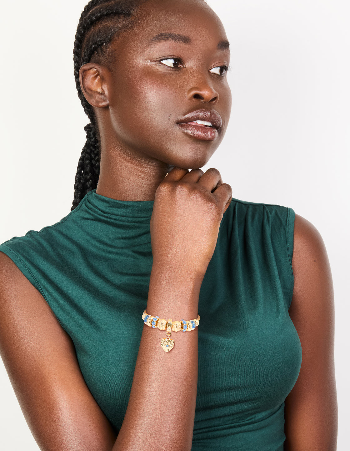 Explore a gold blue diamante and molten heart charm toggle bracelet with beaded and balls accents on model view