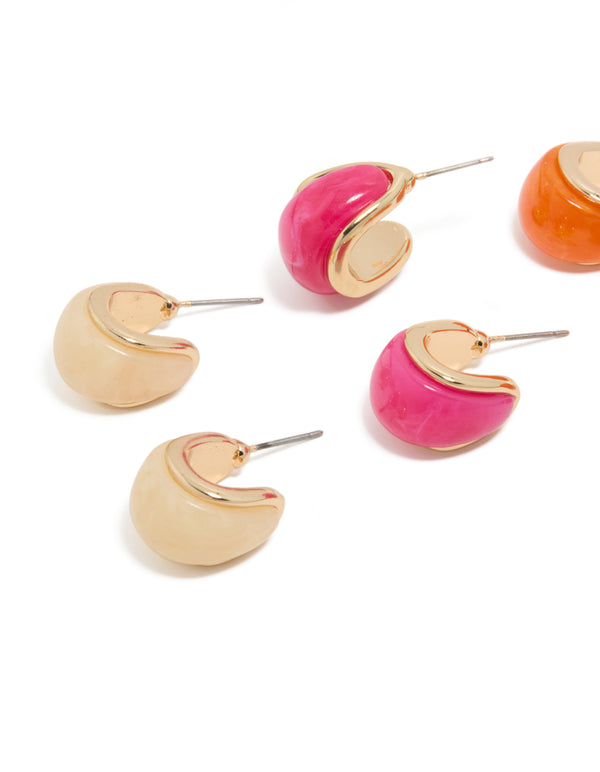 Discover chunky hoop earrings in a 3-pack with gold, hot pink, and orange acrylic bubble accents close up view