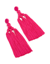 Crafted from hot pink fabric, these statement drop earrings feature beads and tassel detailing front view - link has visual effect only